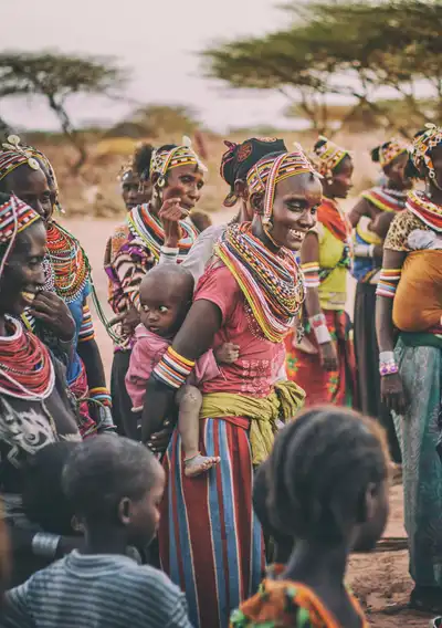 A group of nomadic female humans seen here with their children. Photo by Ian Macharia from Unsplash.